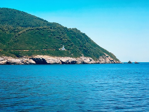 View on lighthouse Gourouni on Skopelos island, Greece from ferry.