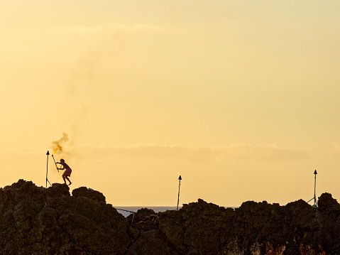 The Pacific Island of Maui in Hawaii on January  11, 2023:  Black Rock Kaanapali Sea cliffs torch lighting  ceremony at sunset on Maui, Hawaii, USA