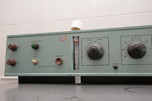 A close-up of a control panel with buttons and switches used to monitor and measure pressure levels