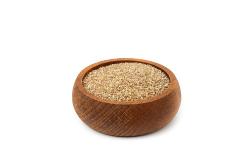 Wooden Bowl Full of Dry raw bulgur isolated on white background.