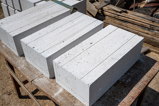 White aerated concrete blocks close-up. Laying aerated concrete blocks. Construction of a house from aerated concrete blocks and bricks.