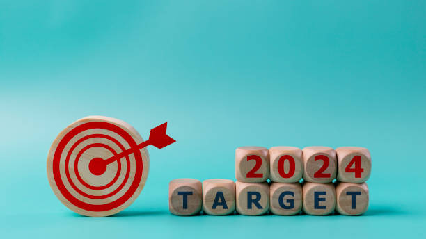 istock Business target and dartboard with the word Target 2024 on blue background. 2024 target concept. 1670461683