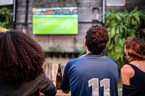 Sports fans watching a match at bar