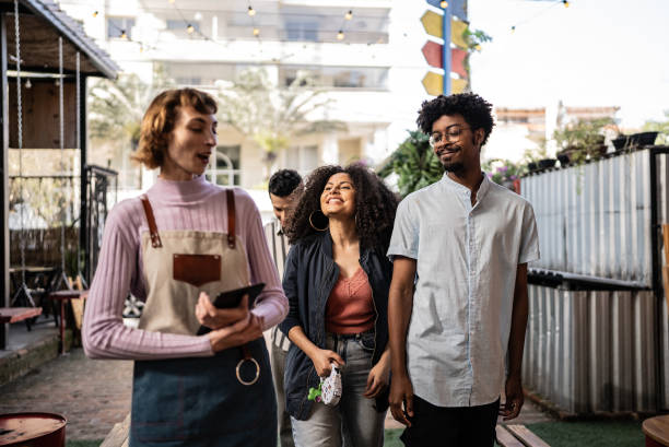 istock Friends talking with waitress at bar or restaurant 1670579236