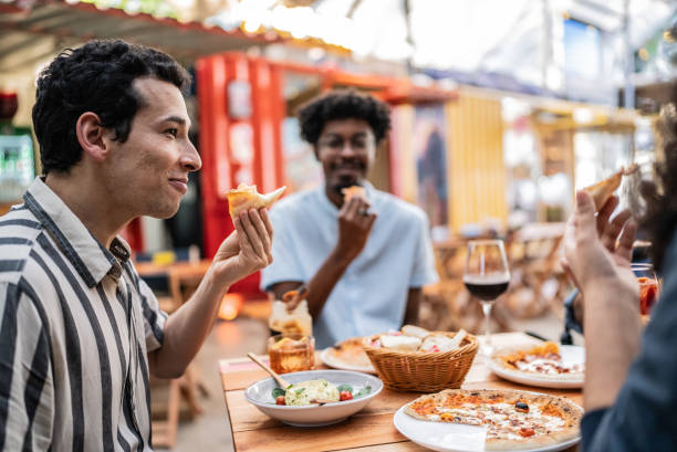 istock Friends talking and eating a pizzeria or restaurant 1670584069