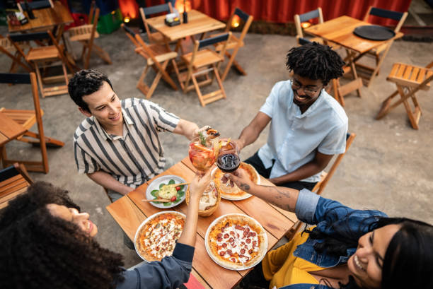 istock Friends toasting drinking glass at bar 1670585740