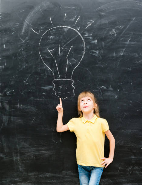 istock cute little girl pointing on a drawn lamp 1670667532