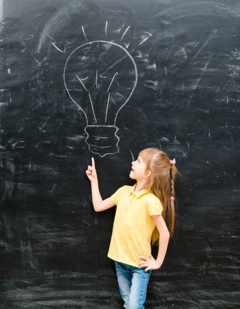 istock cute little girl pointing on a drawn lamp 1670667533