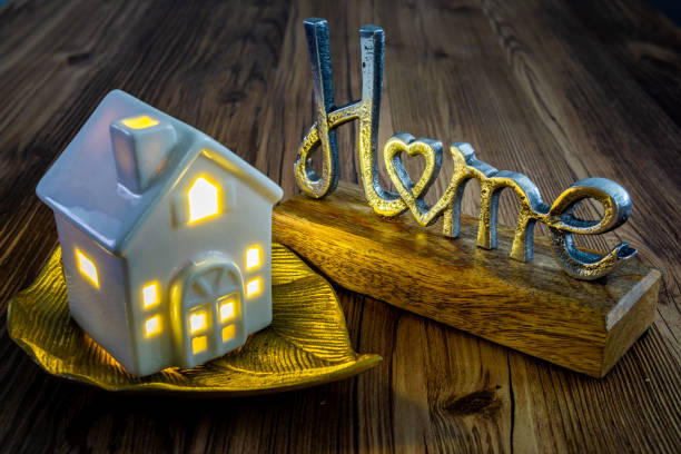 istock metal home sing ceramic house with light on in the background 1670672522