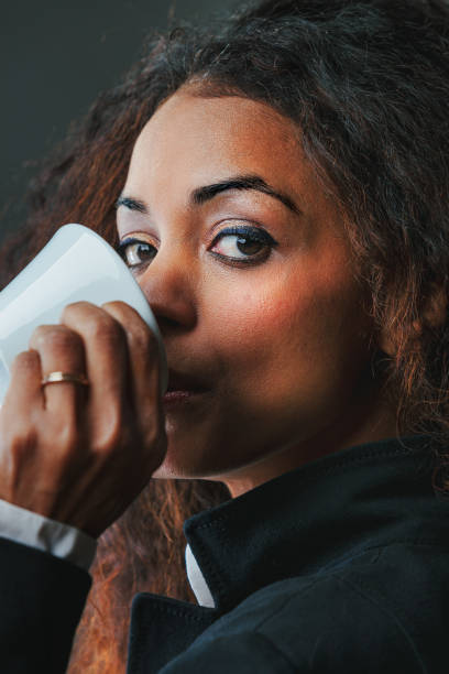 istock Black woman, sipping coffee, exudes power, knowledge 1670698535