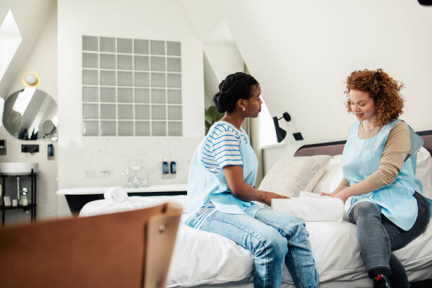 istock Two young maids at the hotel taking a break after preparing the room 1670728612