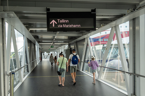 Stockholm, Sweden Aug 21, 2023 A family walk in the ferry terminal towards the Tallink ferry to Tallinn, Estonia.