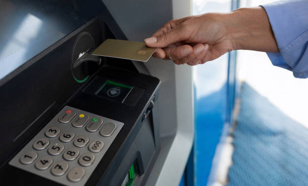 istock a woman held a plastic card to an ATM 1670740096