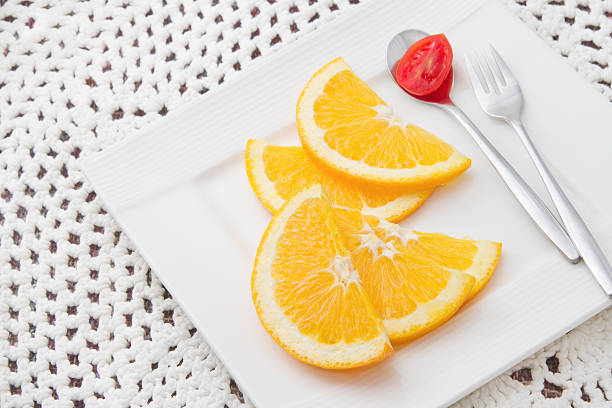 istock sliced oranges  with red tomato on the spoon 167080707