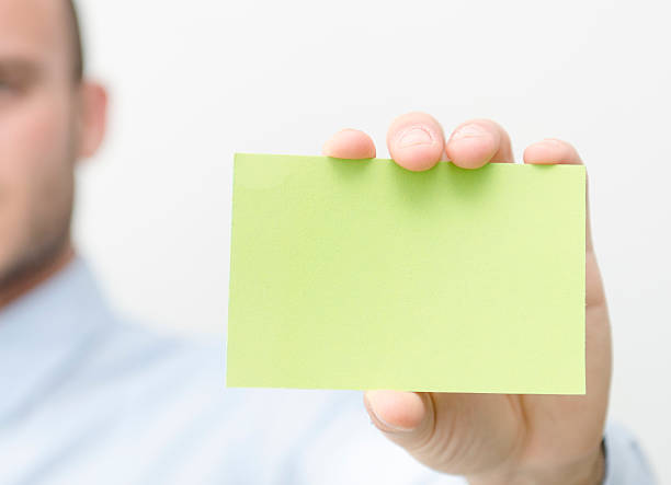 istock Man showing a green Business Card 167083745