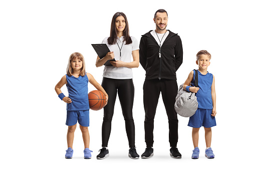 Children with basketball standing with PE teachers isolated on white background