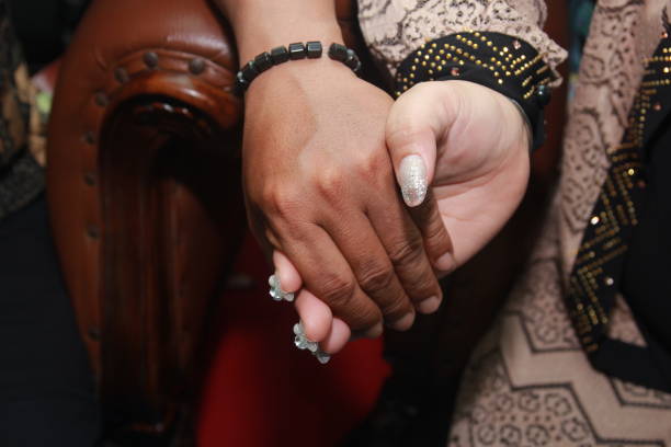 istock close-up of the joined hands of two lovers 1670880400