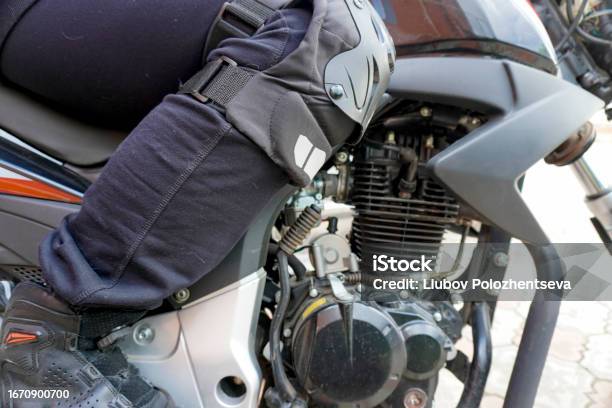 Woman Motorcyclist In A Motorcycle Boots On A Motorcycle Closeup Stock Photo - Download Image Now