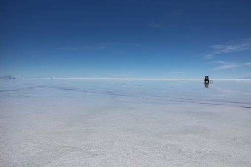 A car on Uyuni salt lake in Bolivia