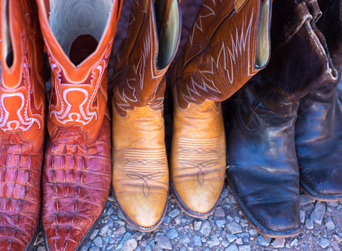 Three Pair Old Cowboy Boots. Close-up shot.