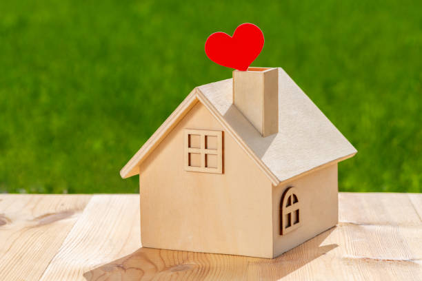 istock Ecological concept plot with wooden miniature house on nature background under sunlight 1670964832
