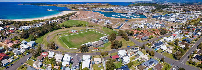 Panoramic aerial drone view of Shellharbour looking over Shellharbour South Beach and Shellharbour Marina on the New South Wales South Coast, Australia on a sunny day