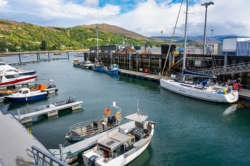 Boats docked in the port of the tourist town of Ullapool in Scotland