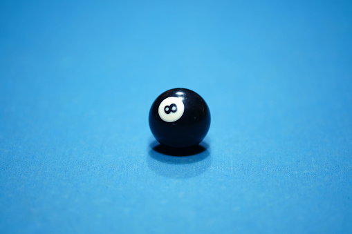 Ball number 8 in a game of billiards before it is struck. Sport and game photography