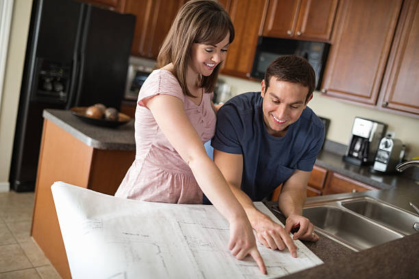 istock Couple Pointing And Looking At Blueprint 167118926