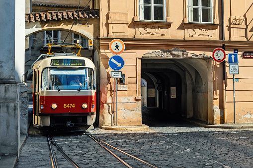 Prague, Czech Republic - September 02, 2019: Tram on the cobblestone street in old historic part of Prague - capital city of Czechia, famous and popular travel destination.