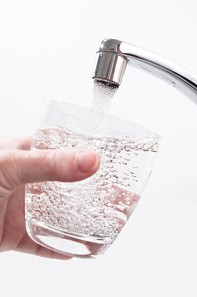 istock Water glass is filled at the tap 167125609