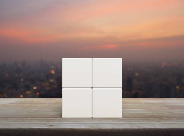 Four white block cubes on wooden table