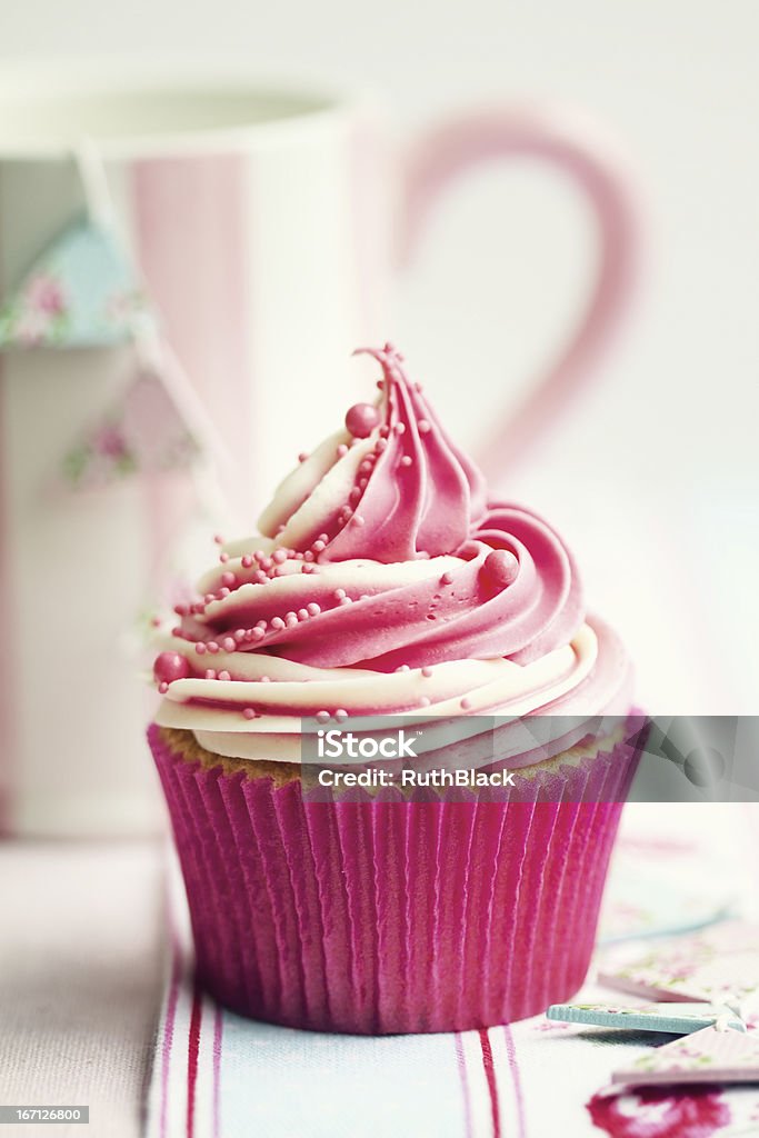 Cupcake Cupcake decorated with a swirl of strawberry and vanilla frosting Baked Stock Photo