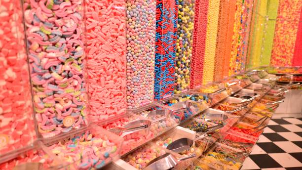 istock Plastic jars filled with colourful candy in shop. 1671299181