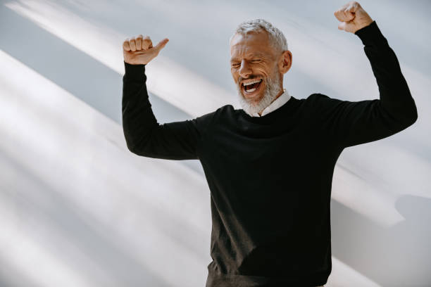 istock Joyful senior man in smart casual wear looking excited while gesturing against the wall 1671305538