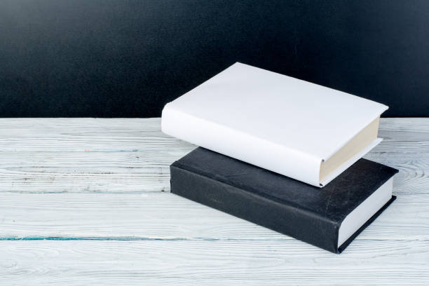 istock Hardback books on wooden table, white background. Back to school. Copy space for text. Education business concept. 1671391610
