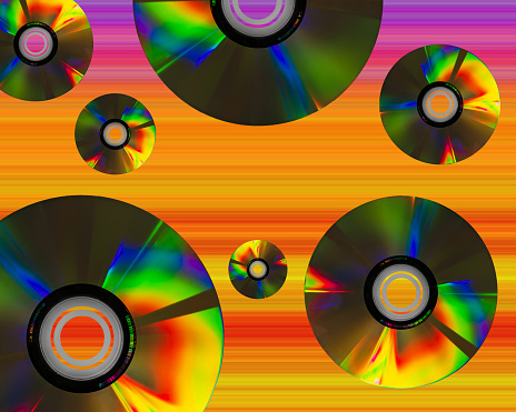 Vintage background with colorful cd. Nostalgia for the 80s and 90s. Orange background. Text space.