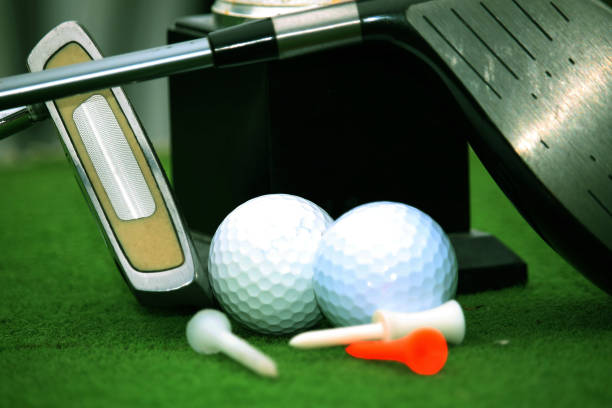 istock Collection of golf equipment resting on green grass 1671395882