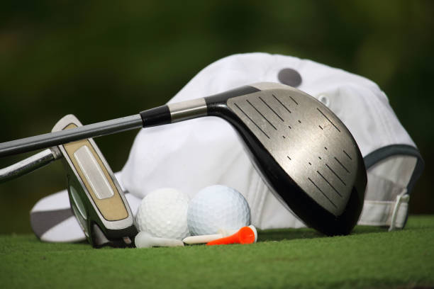 istock Collection of golf equipment resting on green grass 1671396929