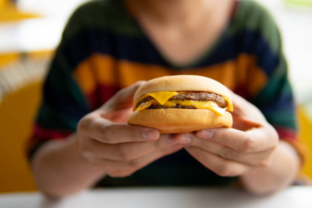 istock Close up women eating hamburger 1671405754