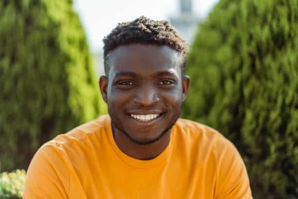 Authentic portrait of handsome smiling African American man looking at camera