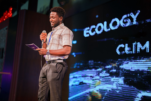 Conference speakers showing presentations on the stage