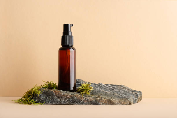 Mock up glass pump bottle on a moss stone podium