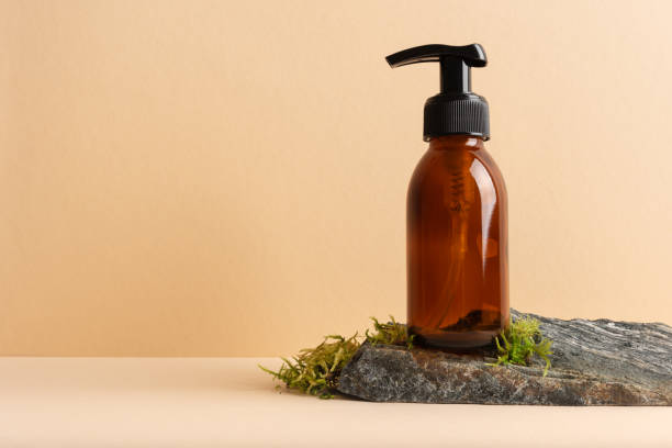 istock Mock up glass pump bottle on a moss stone podium 1671471264