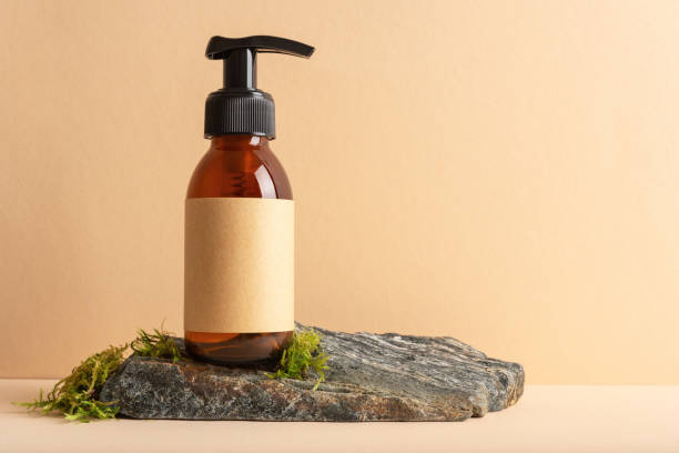istock Mock up glass pump bottle on a moss stone podium 1671471460