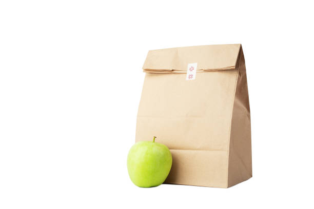 istock Lunch bag with apple isolated, takeaway delivery box, responsible wrapping 1671474830