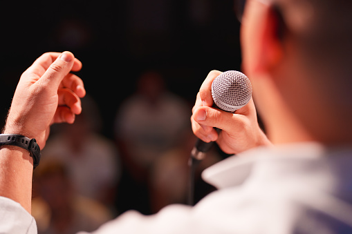 Conference speakers showing presentations on the stage