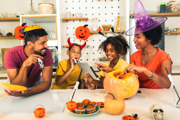 istock Family has fun in Halloween time make video call with digital tablet. 1671493346
