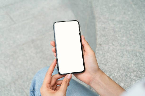 istock Hand holding black smartphone with blank screen for graphic display montage at shopping mall background. 1671494475