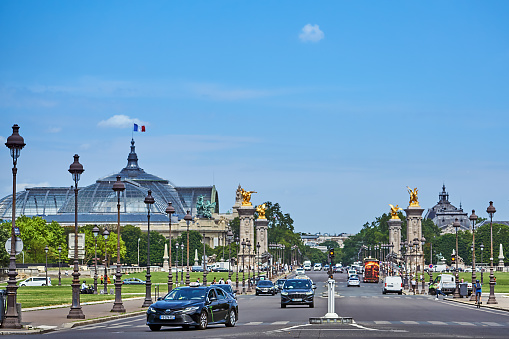 Paris, France - July 11, 2023: Pedestrians and traffic on Avenue du Marechal Gallieni. In the background the Grand Palais.